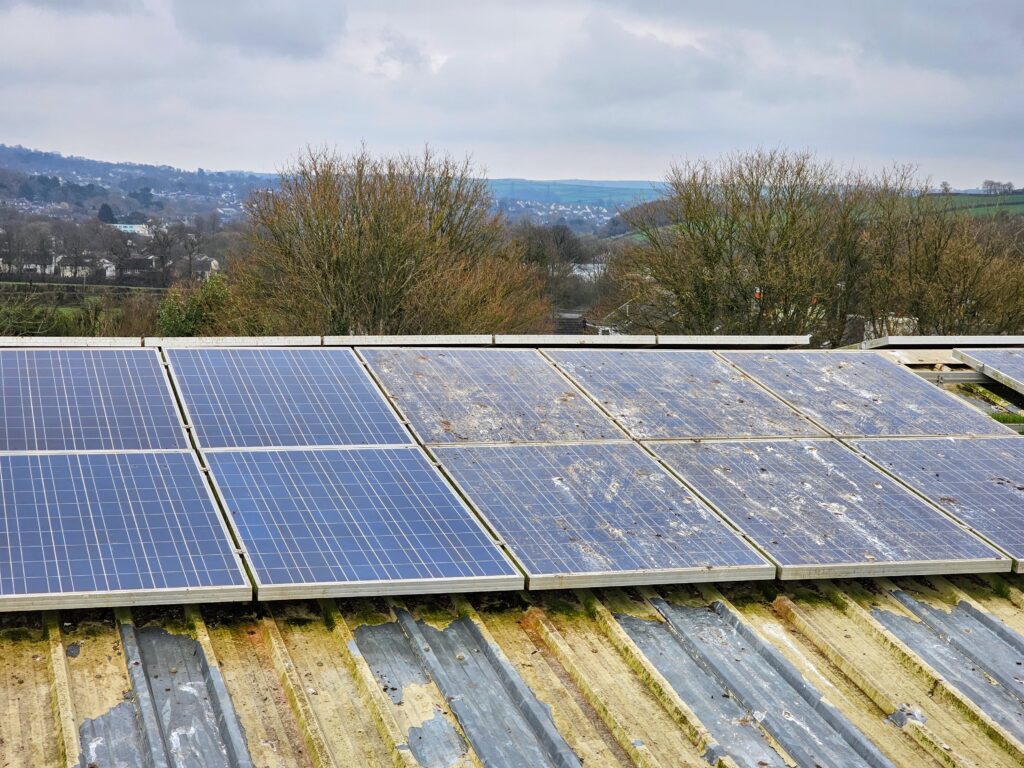 Solar panels with the left half cleaned and the right half still dirty